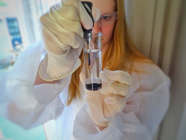 Scientist carefully handling test tube- Nova Arc Content Co. -we can handle your scientific and technical writing and editing needs